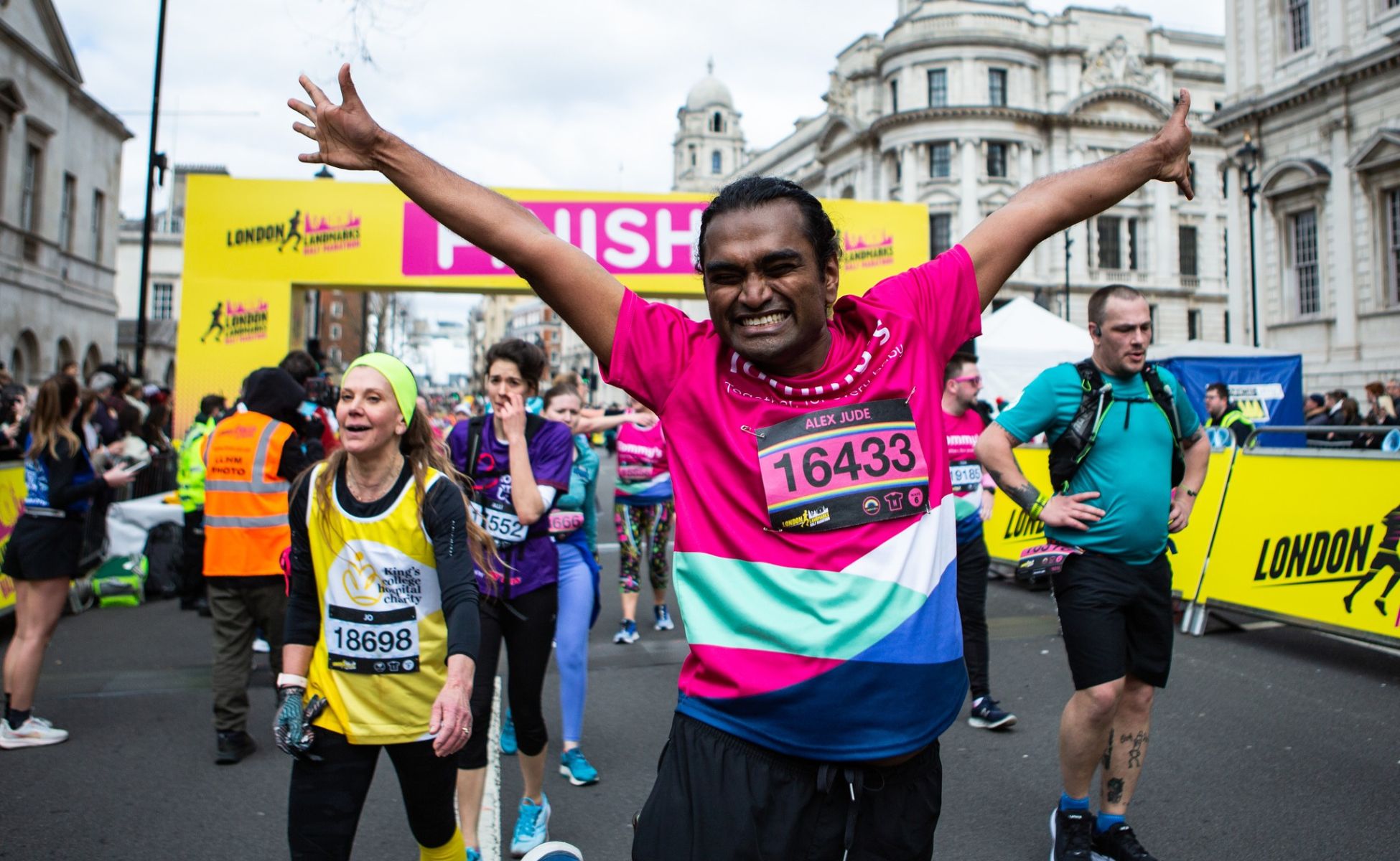Man celebrating at the finish line of the London Landmarks Half Marathon