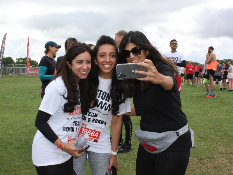 Three women in Winston's Wish t-shirts taking a picture at the Inflatable 5k